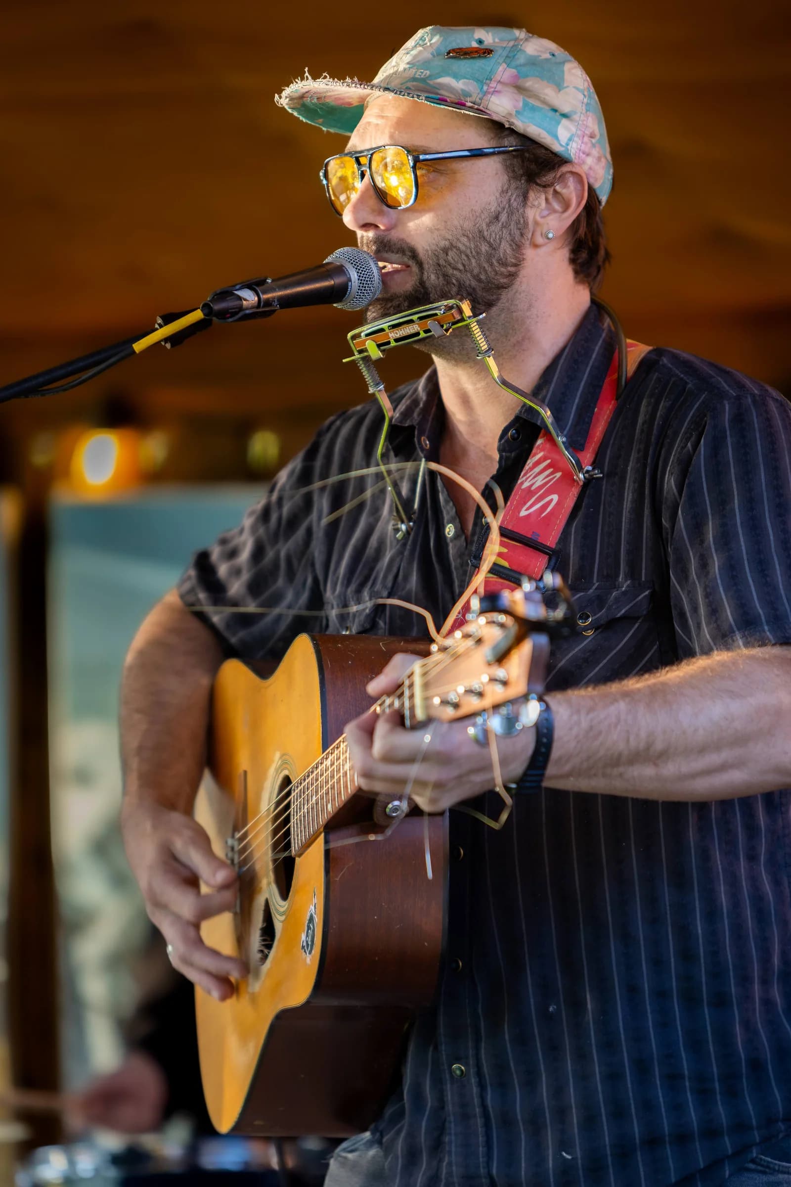 A member of Rut Nut on harmonica and guitar at Terminal Gravity Brewing in Enterprise on the Friday of Juniper Jam week, September 4, 2026.